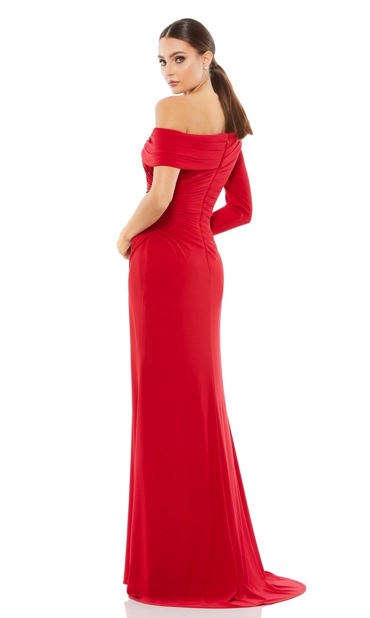 A woman stands sideways against a white background wearing the Mac Duggal 26570 Drop-Shoulder Long Formal Dress, featuring a fitted silhouette and floor-length hem.